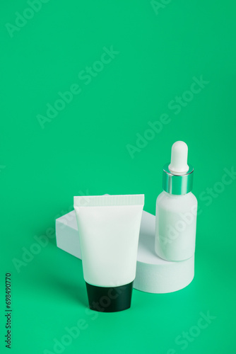 Serum skin care product on green background with skincare healthcare concept on green background.