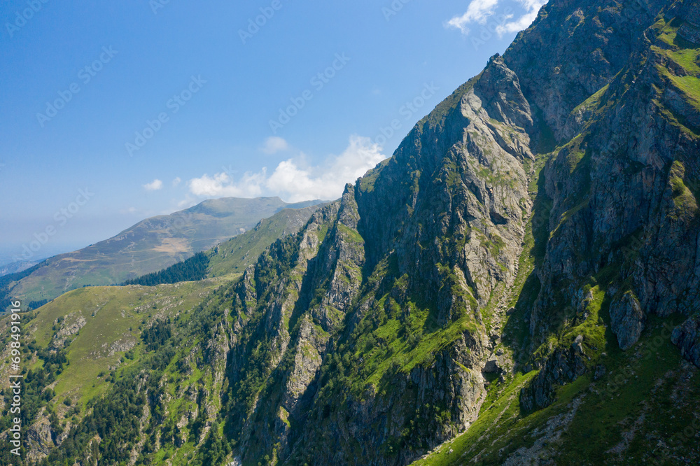 The green countryside in the mountains , Europe, France, Occitanie, Hautes-Pyrenees, in summer on a sunny day.