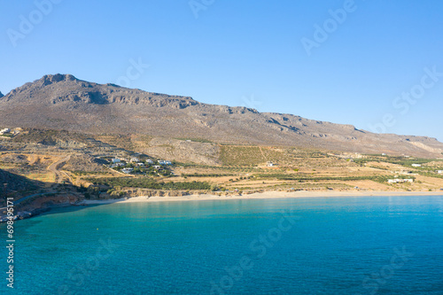 Fototapeta Naklejka Na Ścianę i Meble -  The sandy beach of Ambelou at the foot of the mountains , in Europe, Greece, Crete, towards Zakros, By the Mediterranean Sea, in summer, on a sunny day.