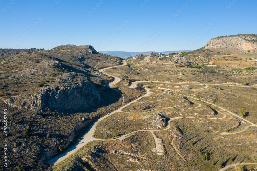Peaks of a rocky mountain in the arid countryside , Europe, Greece, Peloponnese, Argolis, Nafplion, Myrto seashore, in summer on a sunny day.