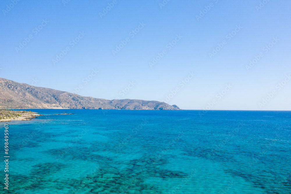 The rocky coast and its arid mountains , in Europe, Greece, Crete, Elafonisi, By the Mediterranean Sea, in summer, on a sunny day.
