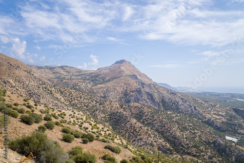 The rocky and arid mountains in the countryside , Europe, Greece, Crete, towards Myrtos, By the Mediterranean sea, in summer, on a sunny day. © Florent