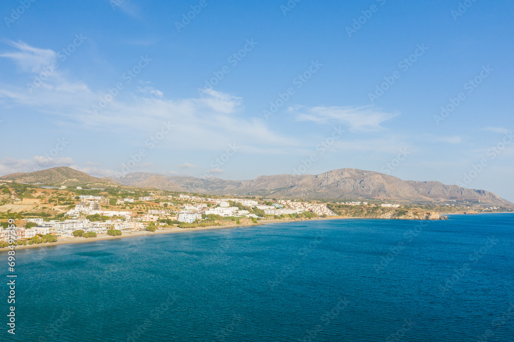 The paradise coast and the sandy beach at the foot of the mountains, in Europe, Greece, Crete, Analipsi, By the Mediterranean Sea, in summer, on a sunny day.