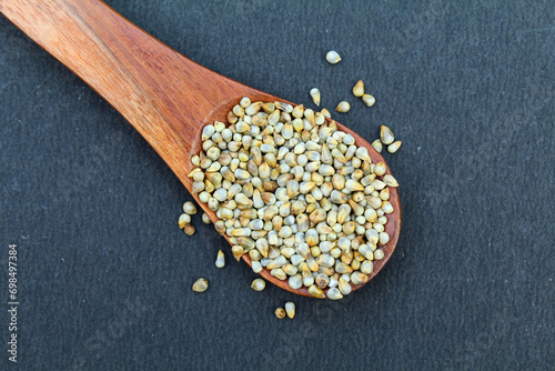 Organic Pearl millet or bajra in a wooden spoon close-up view  photo