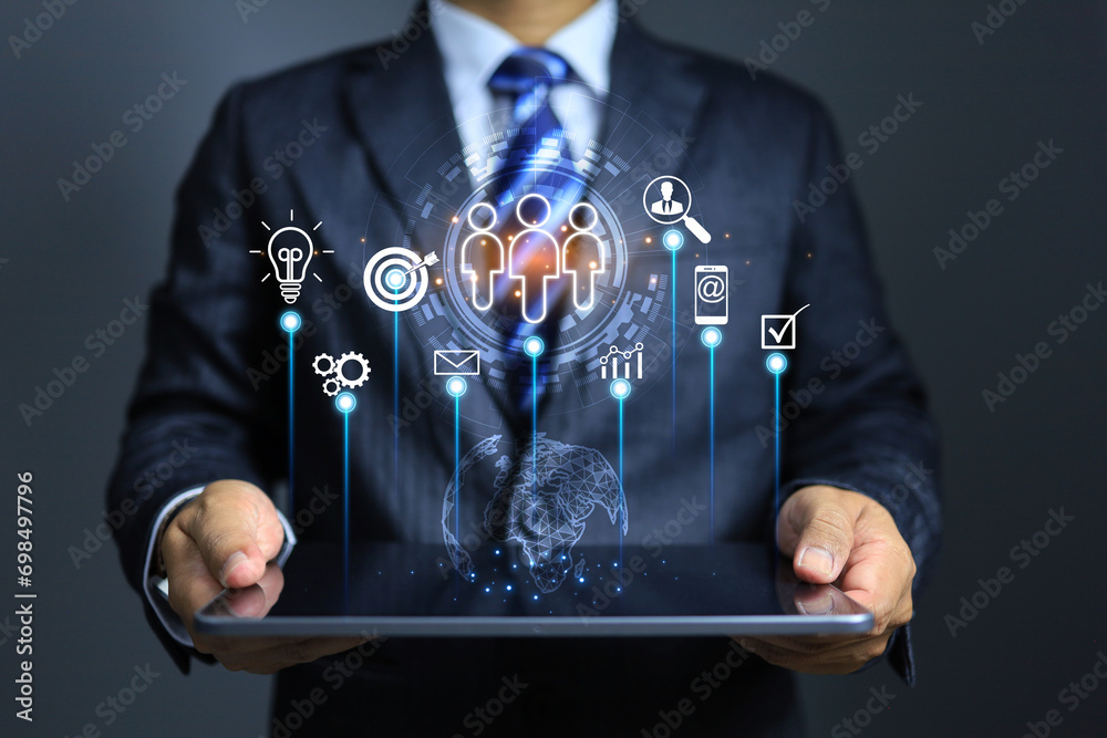 CRM customer relationship concept with businessman holding tablet and working on network system to global customer service and support for best experience - obrazy, fototapety, plakaty 