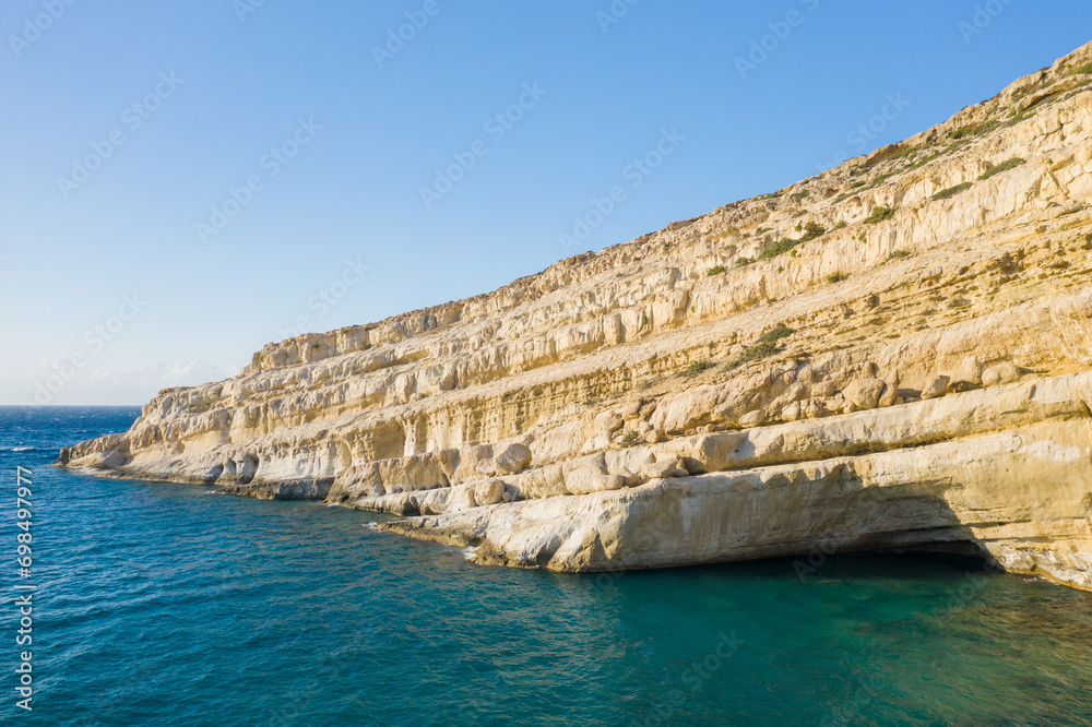 The caves in the rocky and limestone cliffs , in Europe, Greece, Crete, Matala, By the Mediterranean Sea, in summer, on a sunny day.