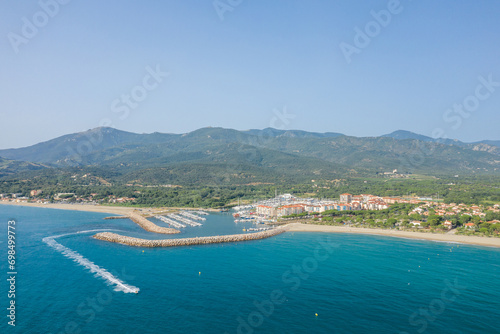 The white sand beach on the green coast in Europe, France, Occitanie, Pyrenees Orientales, Argeles, By the Mediterranean Sea, in summer, on a sunny day. photo