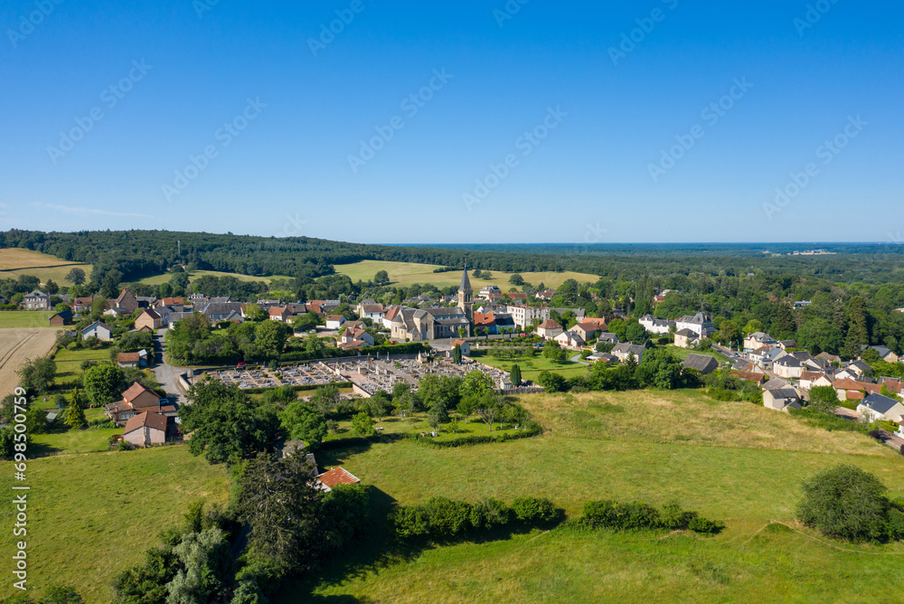 Fototapeta premium A traditional village old seaside resort in the middle of the countryside in Europe, France, Burgundy, Nievre, Saint-Honoré-les-Bains, towards Chateau Chinon, in summer on a sunny day.