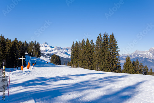 A Megeve ski slope in the middle of the mountains of the Mont Blanc massif in Europe, France, Rhone Alpes, Savoie, Alps, in winter, on a sunny day. © Florent