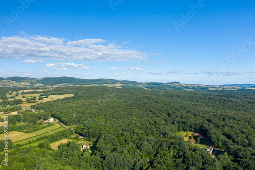 The green countryside with forests and fields in Europe, France, Burgundy, Nievre, towards Chateau Chinon, in summer, on a sunny day.