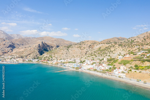 The city center at the foot of the arid mountains , in Europe, Greece, Crete, Tsoutsouros, By the Mediterranean Sea, in summer, on a sunny day.