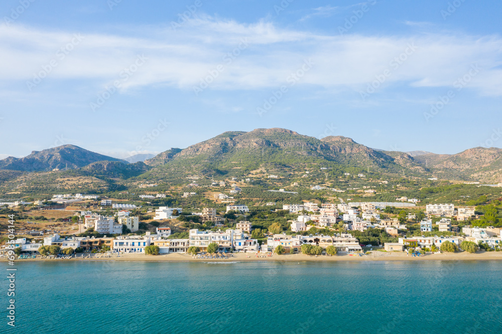 The paradise coast and the sandy beach at the foot of the mountains, in Europe, Greece, Crete, Analipsi, By the Mediterranean Sea, in summer, on a sunny day.