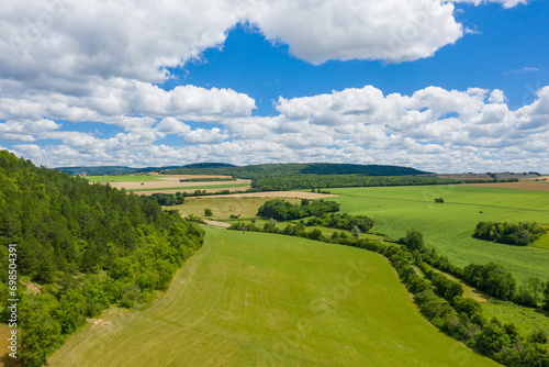 The countryside with its forests and green fields in Europe, France, Burgundy, Nievre, towards Chateau Chinon, in summer, on a sunny day.