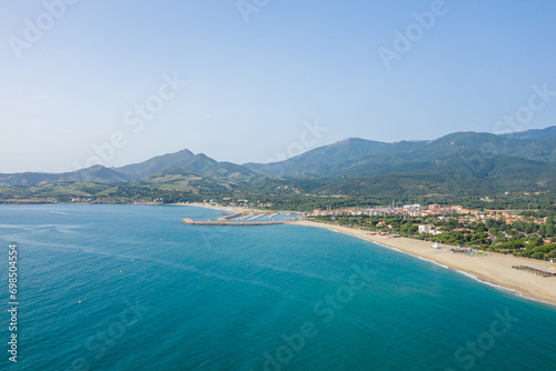The white sand beach on the green coast in Europe, France, Occitanie, Pyrenees Orientales, Argeles, By the Mediterranean Sea, in summer, on a sunny day.