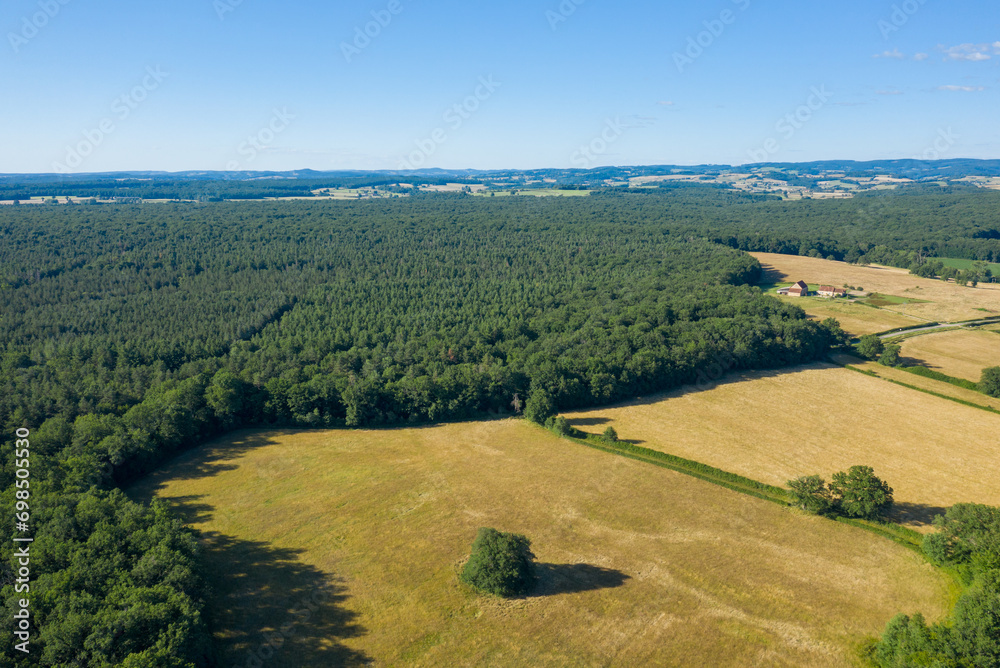 The green countryside with forests and fields in Europe, France, Burgundy, Nievre, towards Chateau Chinon, in summer, on a sunny day.