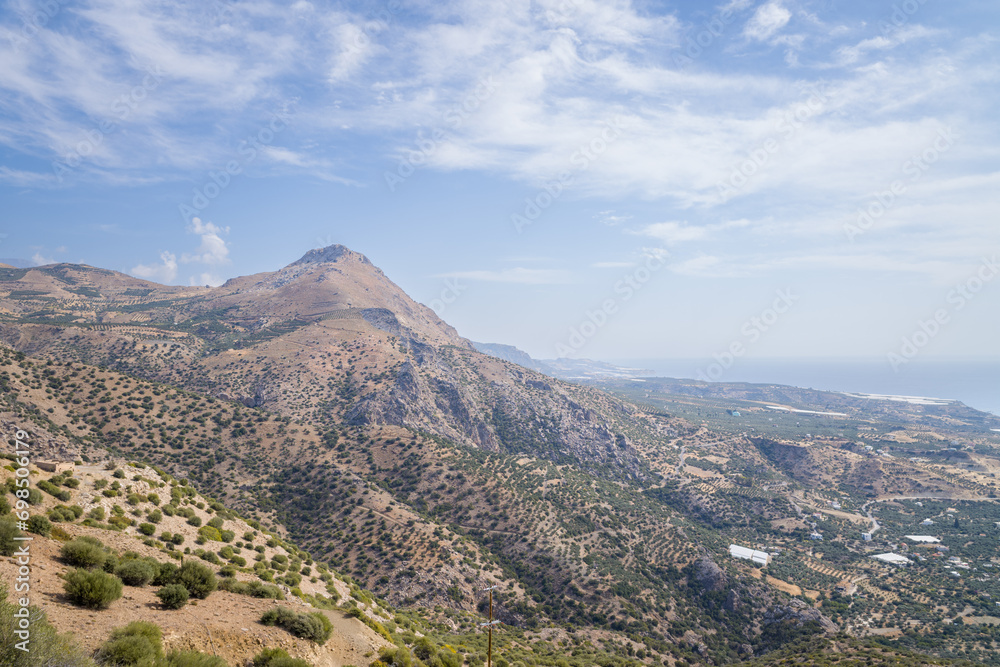 The rocky and arid mountains in the countryside , Europe, Greece, Crete, towards Myrtos, By the Mediterranean sea, in summer, on a sunny day.