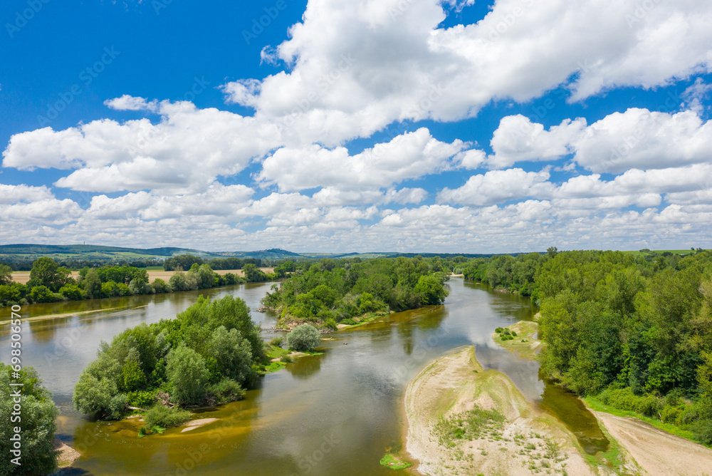 Loire river in the middle of green countryside in Europe, France, Burgundy, Nievre, Pouilly sur Loire, towards Nevers, in summer, on a sunny day.