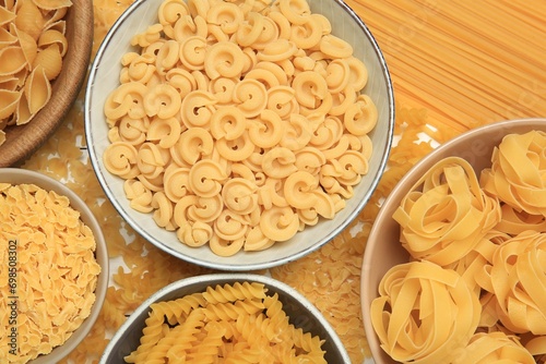 Different types of pasta on table, flat lay