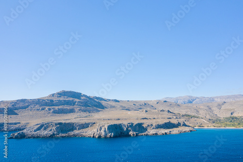 The barren rocky coast and mountains   in Europe  Greece  Crete  towards Sitia  By the Mediterranean sea  in summer  on a sunny day.