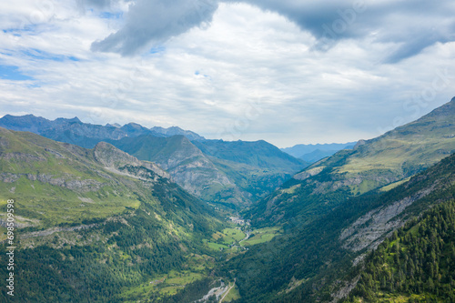 The Gavarnie Valley in the middle of the mountains and its green countryside , in Europe, in France, Occitanie, in the Hautes-Pyrenees, in summer, on a sunny day.