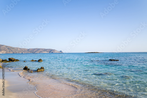 Fototapeta Naklejka Na Ścianę i Meble -  The sandy beach and its heavenly colored water, in Europe, Greece, Crete, Elafonisi, By the Mediterranean Sea, in summer, on a sunny day.