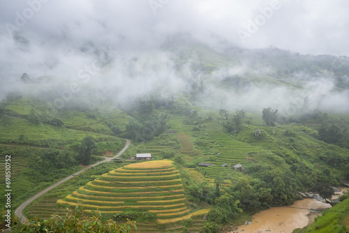 A river in the middle of green mountains, Asia, Vietnam, Tonkin, Bac Ha, towards Lao Cai, in summer, on a cloudy day. photo