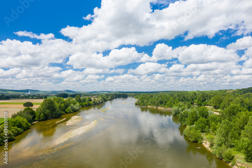 Loire river in the middle of green countryside in Europe, France, Burgundy, Nievre, Pouilly sur Loire, towards Nevers, in summer, on a sunny day.