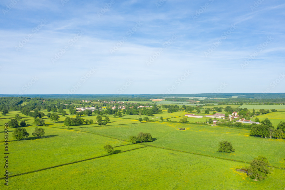 A French village in the green countryside in Europe, France, Burgundy, Nievre, Cuncy les Varzy, towards Clamecy, in Spring, on a sunny day.