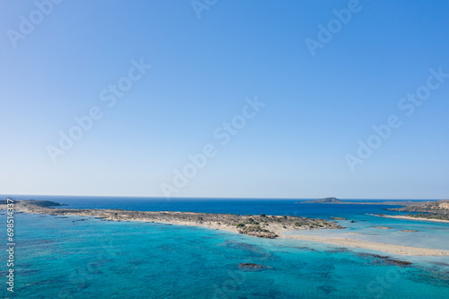 The sandy beach and its heavenly colored water, in Europe, Greece, Crete, Elafonisi, By the Mediterranean Sea, in summer, on a sunny day. © Florent