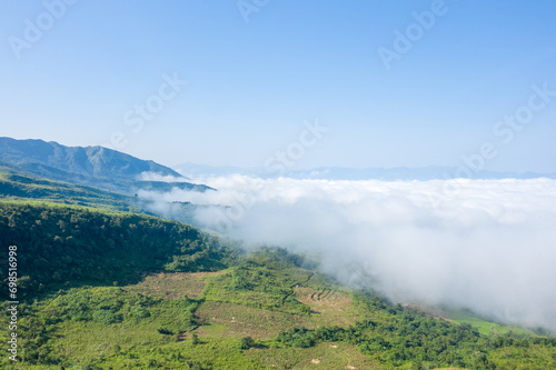 The clouds above the city seen at the green mountains , in Asia, Vietnam, Tonkin, Dien Bien Phu, in summer, on a sunny day. © Florent