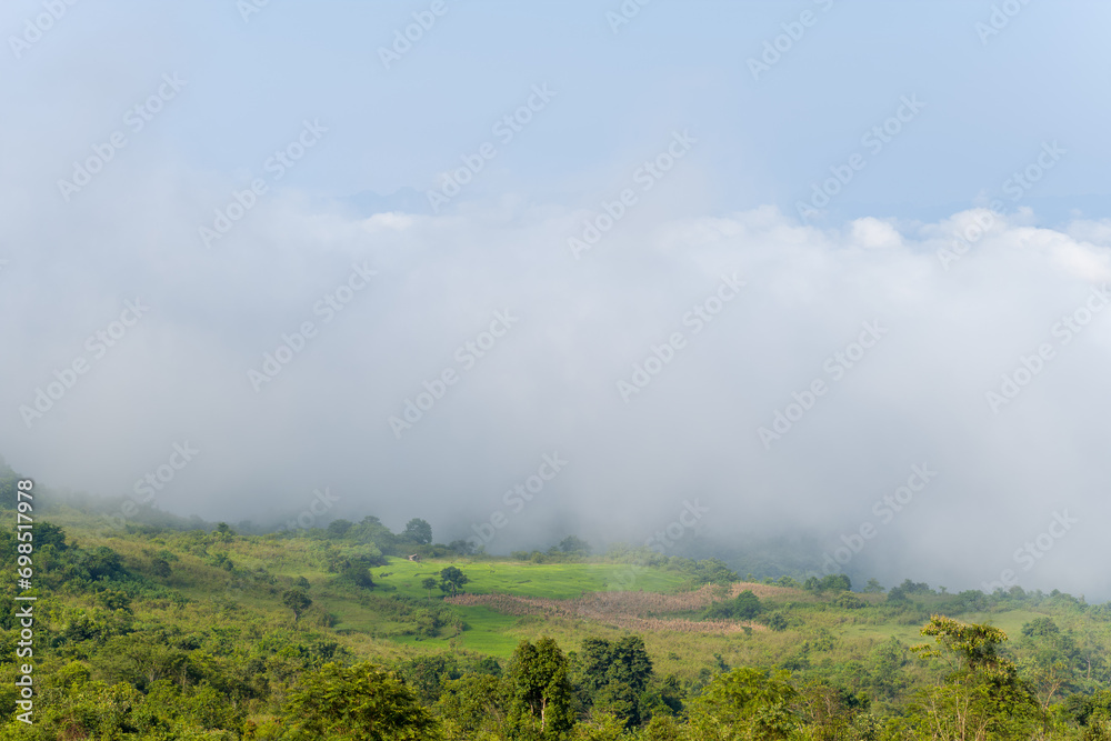 The clouds above the city seen at the green mountains , in Asia, Vietnam, Tonkin, Dien Bien Phu, in summer, on a sunny day.