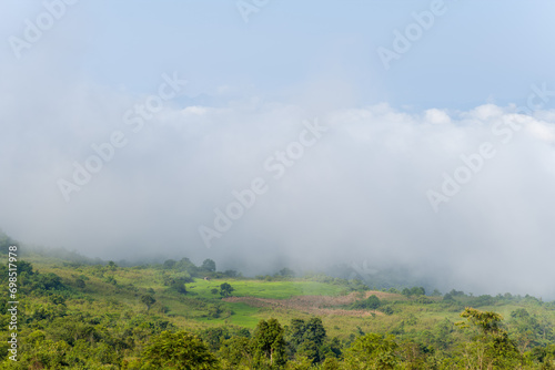 The clouds above the city seen at the green mountains , in Asia, Vietnam, Tonkin, Dien Bien Phu, in summer, on a sunny day.