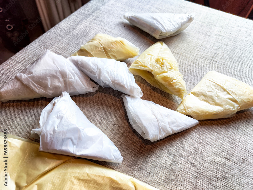 Plastic bag folded into a triangle for storage. Ways of storing and laying at home Plastic bag folded into a triangle for storage. Ways of storing and laying at home