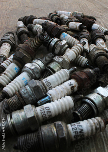 Close-up of spark plugs on the cement floor. 