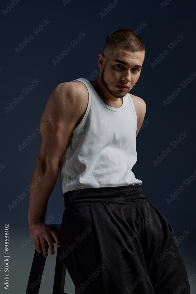 Strength and confidence. Full length portrait of young handsome bristled man posing against gradient blue-white background. Concept of men's health, beauty, body and skin care, fitness. Body art Strength and confidence. Full length portrait of young handsome bristled man posing against gradient blue-white background. Concept of men's health, beauty, body and skin care, fitness. Body art