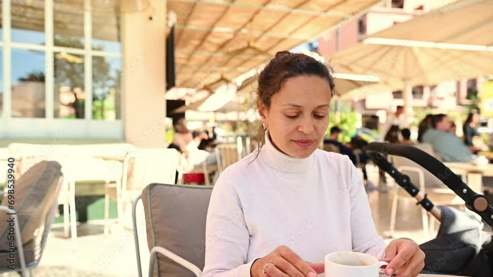 Close-up portrait of a young adult pretty and happy woman smiling looking aside, enjoying her morning coffee outdoor. People. Lifestyle. Leisure activity. Food and drink consumerism Close-up portrait of a young adult pretty and happy woman smiling looking aside, enjoying her morning coffee outdoor. People. Lifestyle. Leisure activity. Food and drink consumerism