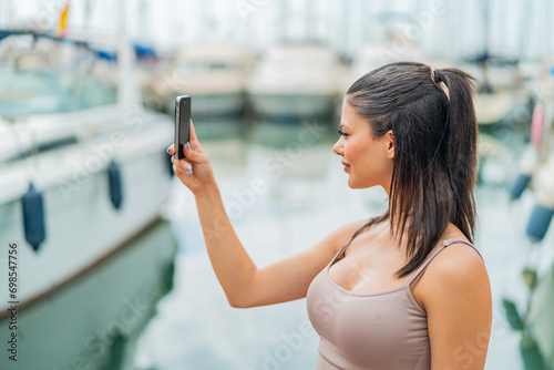 Young pretty woman using mobile phone at outdoors with happy expression