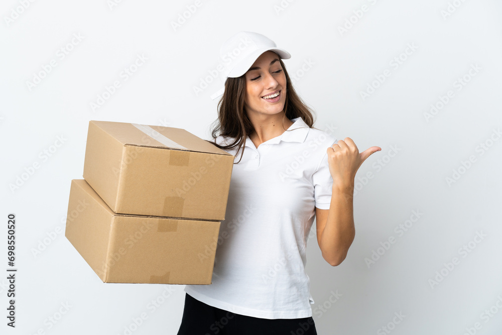 Young delivery woman over isolated white background pointing to the side to present a product Young delivery woman over isolated white background pointing to the side to present a product