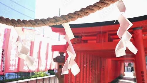 神社の風に揺れる紙垂としめ縄と赤い鳥居 photo
