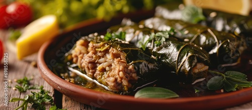 Stuffed grape leaf rolls with minced meat and rice, close-up view. photo