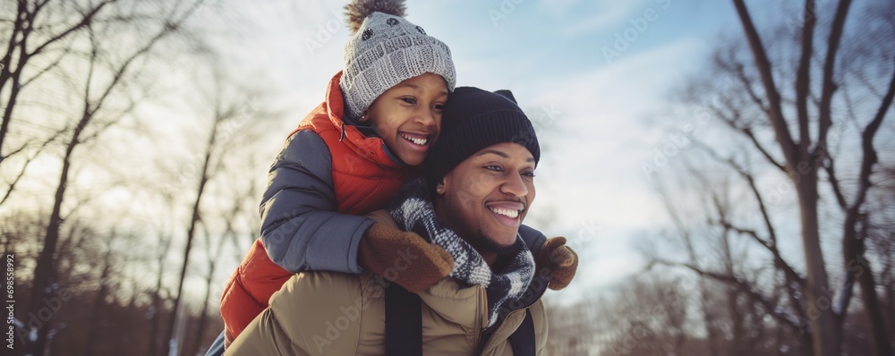 portrait of father carrying his child on his shoulder in winter