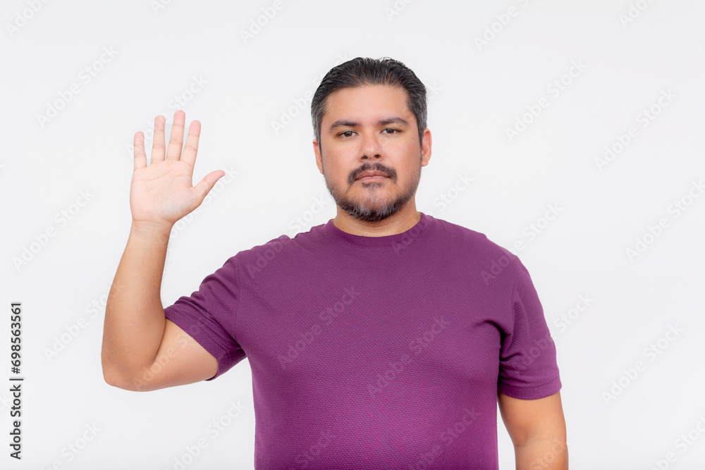 A bearded chubby man makes a solemn oath. Wearing a purple waffle shirt. Half body photo isolated on white background. A bearded chubby man makes a solemn oath. Wearing a purple waffle shirt. Half body photo isolated on white background.