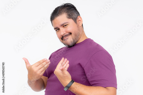 A cocky man points to himself bragging while looking smug. Wearing a purple waffle shirt. Half body photo isolated on white background. photo