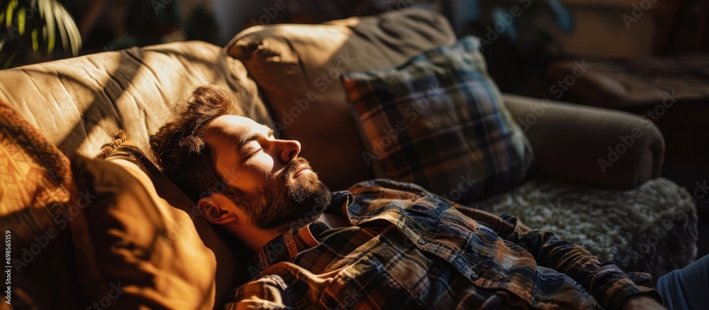 Man napping on couch at home.