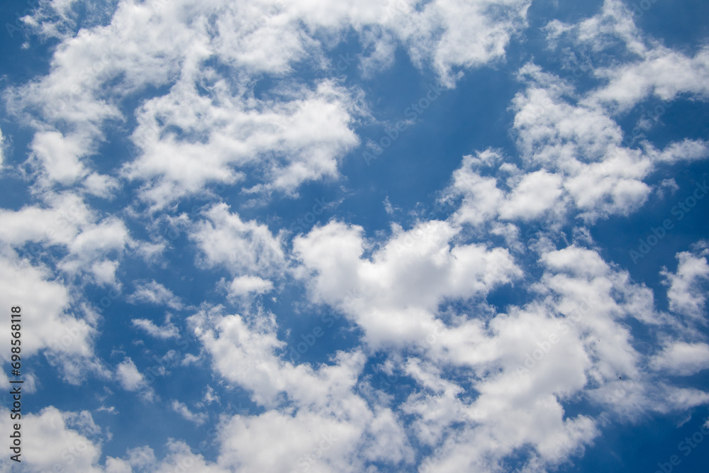 Obraz premium White clouds drift in a blue African sky above the South African Highveld