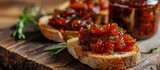 Jar of bacon jam spread on toasted baguette. Close-up.