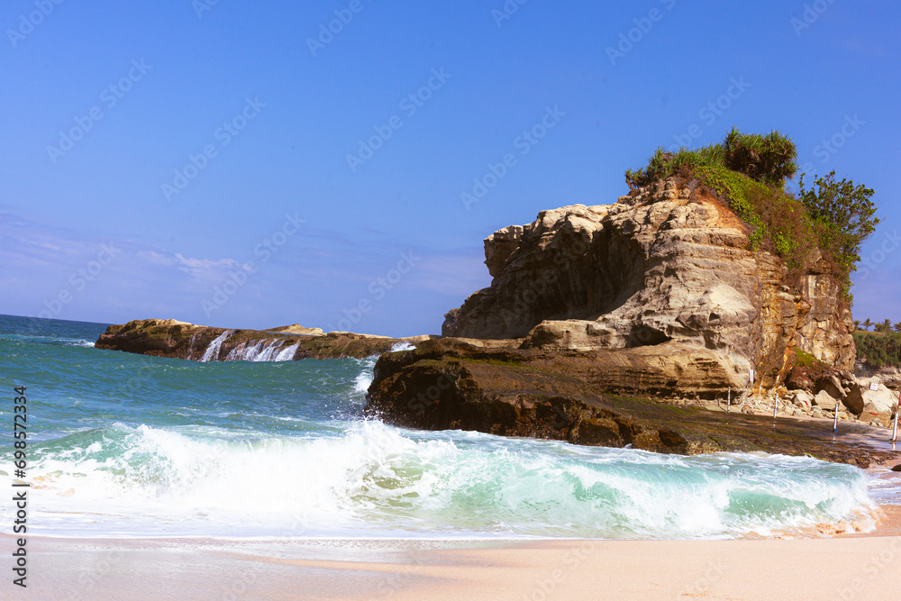 Beautiful beach with waves breaking on the rocks, Pacitan Klayer, East Java, Indonesia