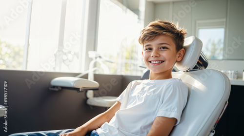 A smiling kid sitting in a dental chair at the dentist, teeth cleaning and examination concept, beautiful white teeth smile, young boy checkup photo