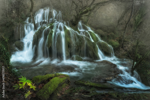 Water falls inside a forest with a winter atmosphere in Andoin, Alava photo