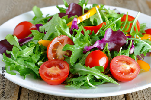 A plate of salad and small tomatoes